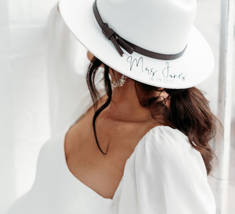 Bride in a personalised fedora hat wedding accessory by Rebecca Anne Designs 