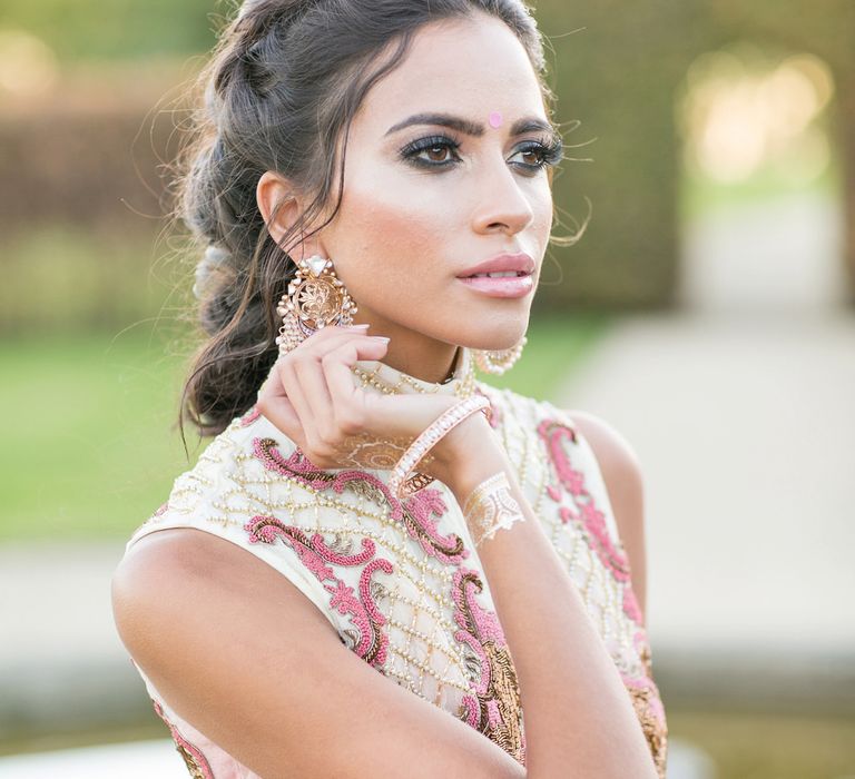 East Asian bride with smokey eye makeup, black mascara, light brown lipgloss and highlighter on her cheeks 