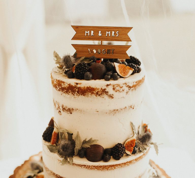 semi naked wedding cake with wooden flag cake topper 