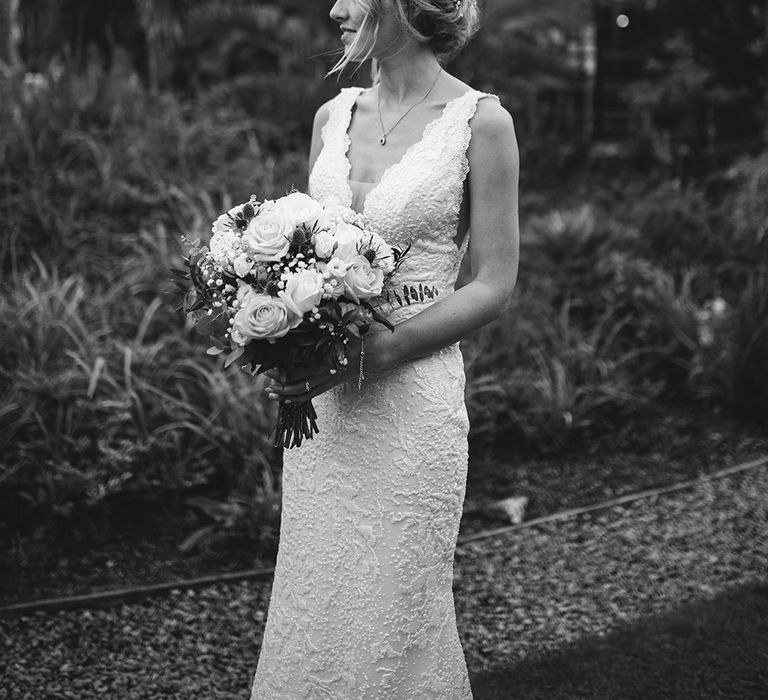 Bride in lace wedding dress with bouquet