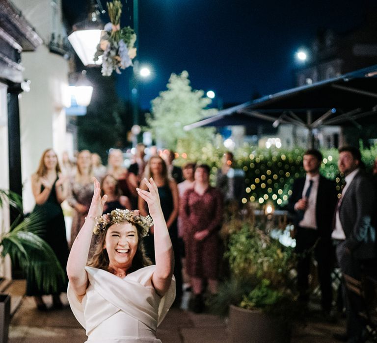 Bride throws her bouquet behind her 