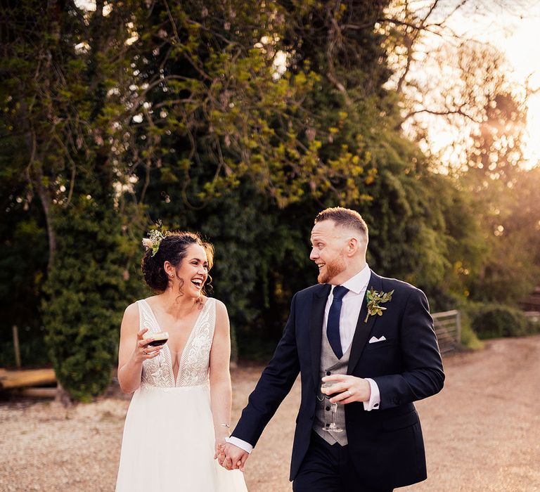 Bride and groom share a cocktail 