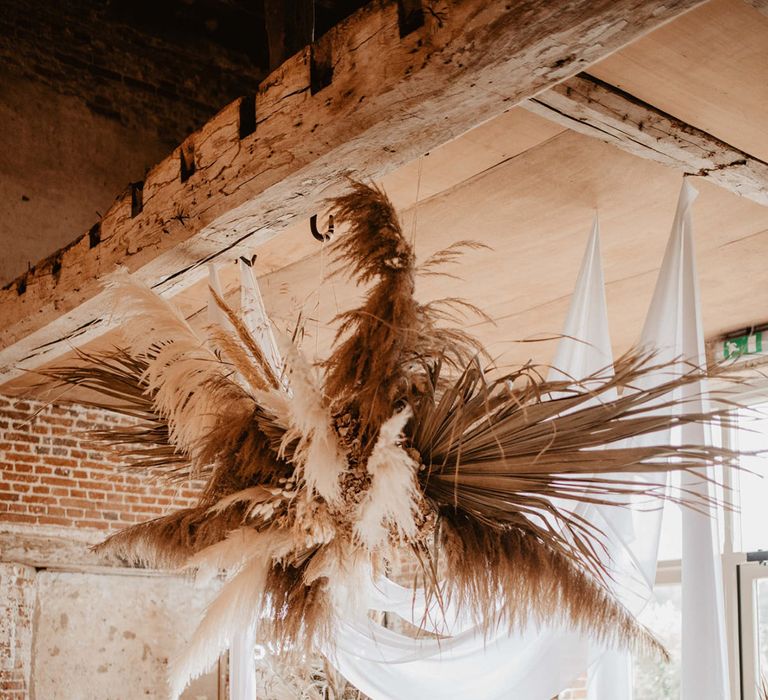 Dried floral pampas grass installation in Godwick Barn Hall