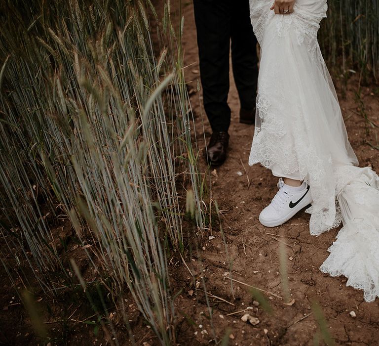 Bride wears white Nike trainers after wedding ceremony