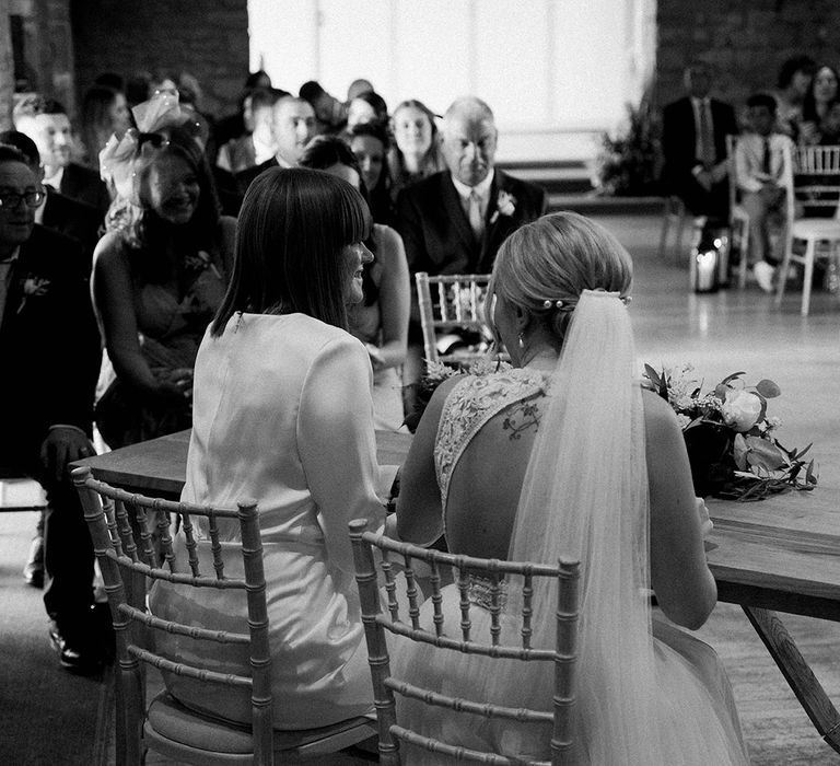 Pinned updo for bride with pearl accessories and veil