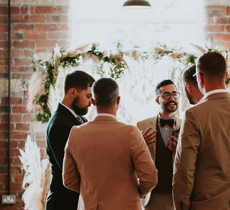 Groom chats to wedding guests on the day of wedding