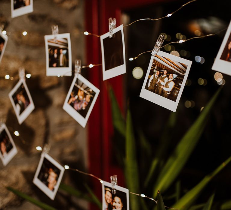 Polaroid pictures hung up for reception decor 