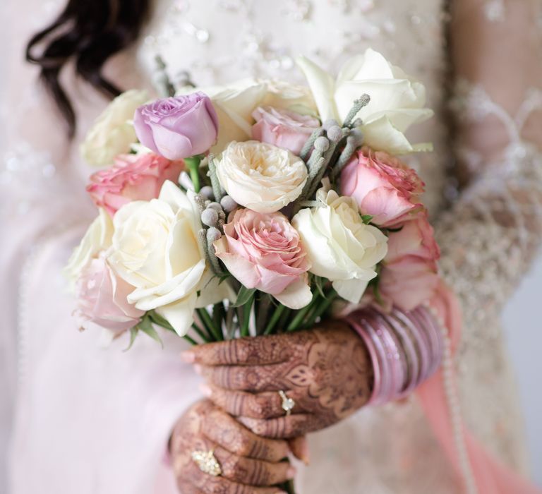 Bride holds pastel bouquet 