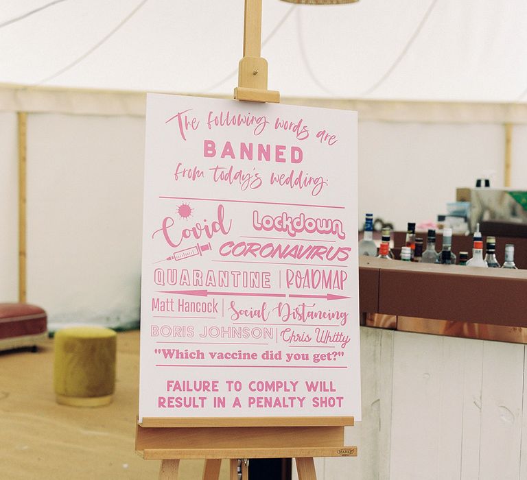 Fun pink wedding sign at marquee wedding