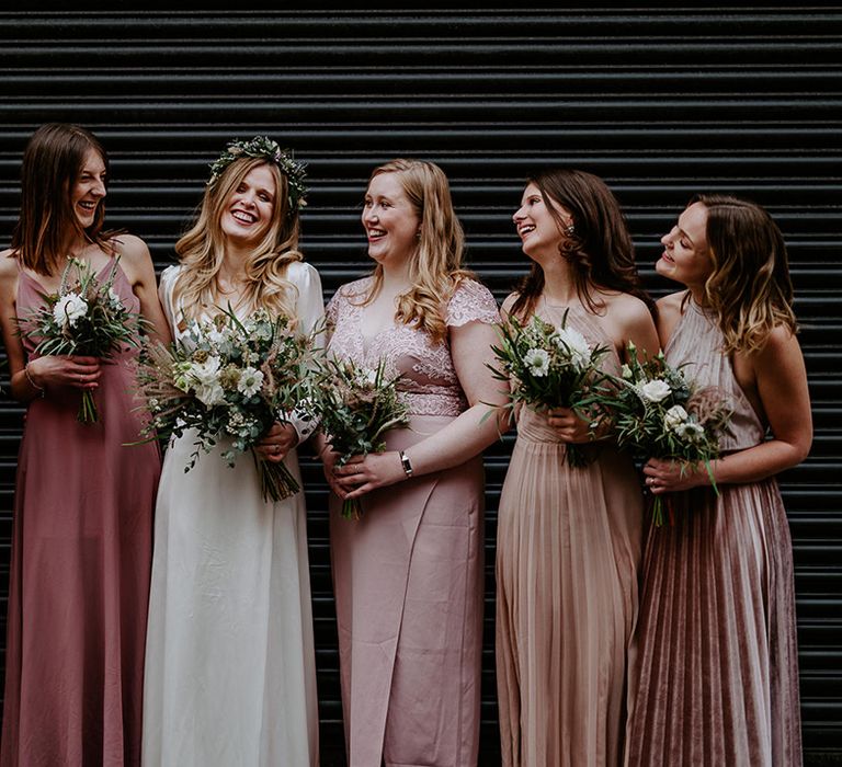 Brides stand with her Bridesmaids on her wedding day