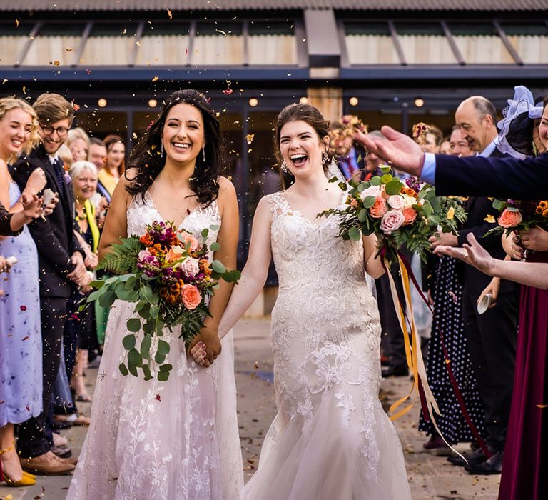 Brides have their confetti exit as wedding guests throw autumnal dried flower confetti 