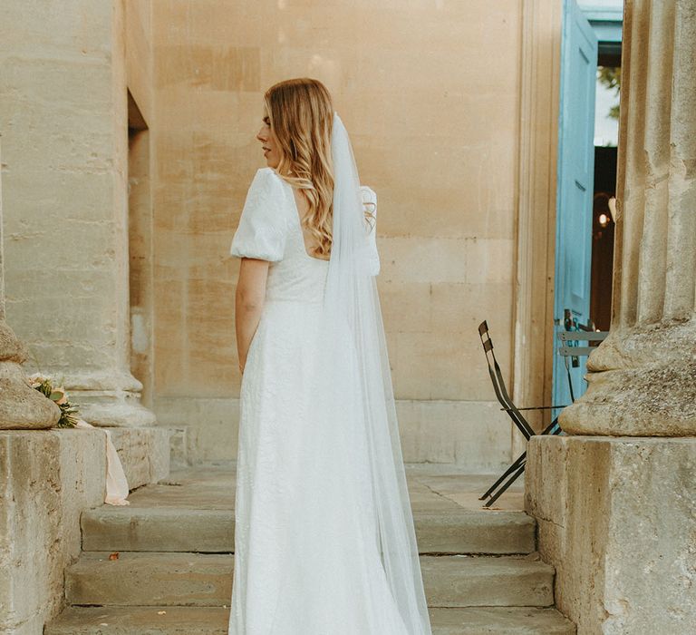 Bride in patterned puff sleeve wedding dress and personalised embroidered veil from Story of My Dress 