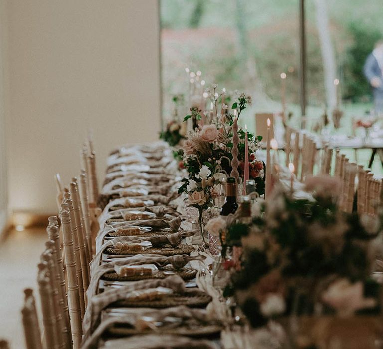 Neutral and pink wedding colour palette table settings with twisted candles and roses for romantic wedding at Millbridge Court