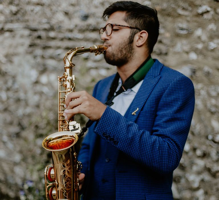 Saxophone player in a blue checkered suit for the wedding entertainment 