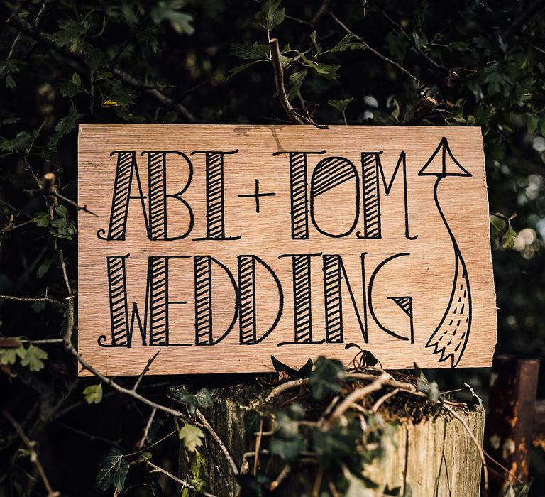 Wooden wedding sign directing guests to the wedding 