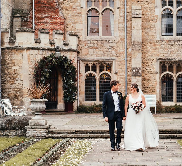 Notley Abbey wedding venue with the groom in black tie and bride in a Maggie Sottero wedding dress 