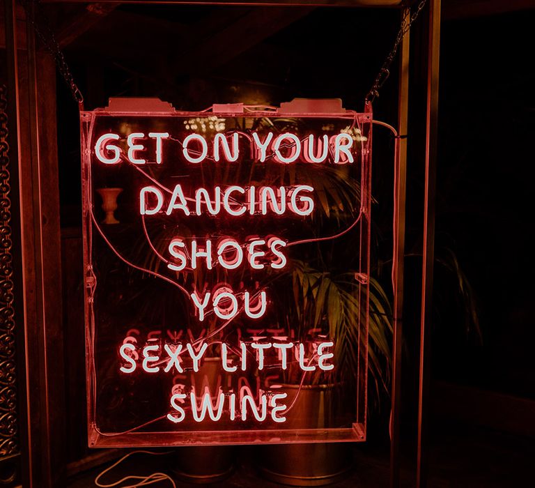 Red neon wedding sign with lyrics from an Arctic Monkeys song 