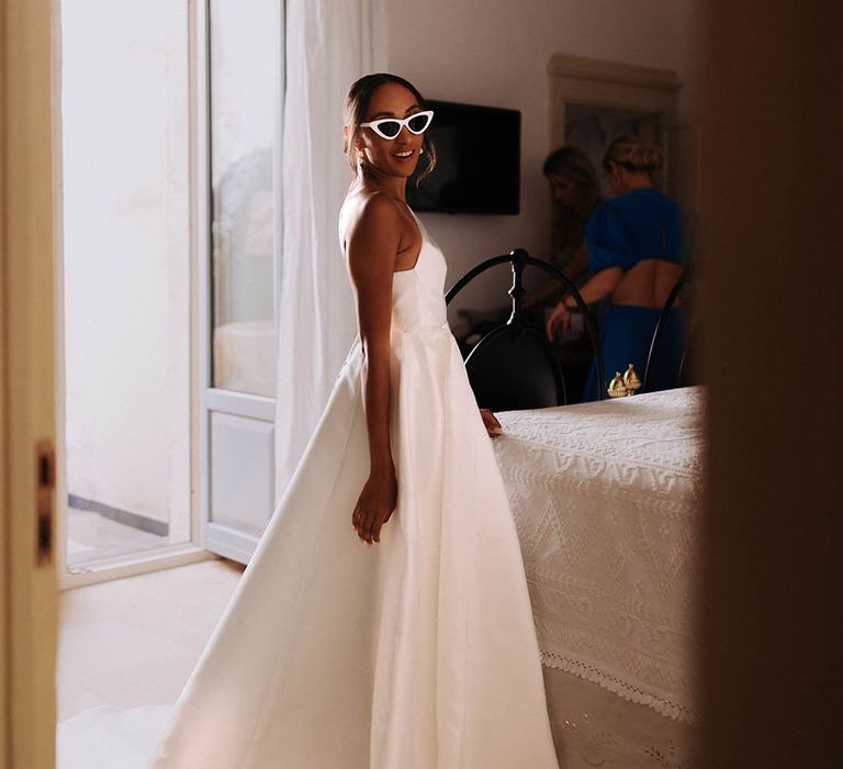 Bride in retro white sunglasses and Jane Hill wedding dress