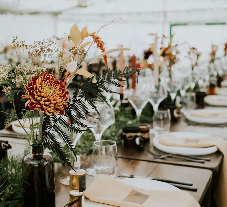 wildflower stems in bottles wedding table decorations 