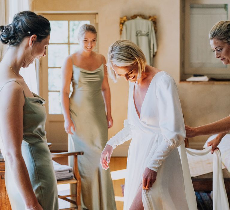 wedding morning bridal party preparations with green sating bridesmaid dresses and front slit wedding dress