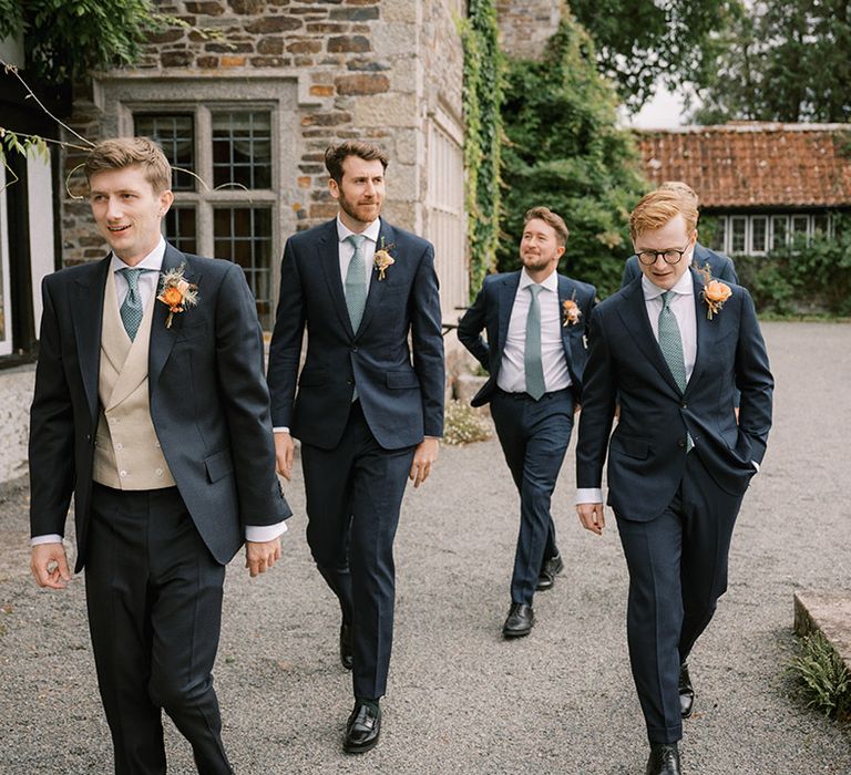 Groom and groomsmen in matching navy suit with green ties for the classic wedding at Coombe Trenchard 