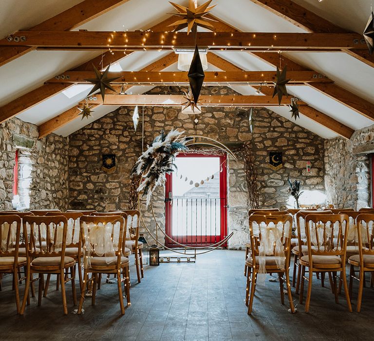 Rustic winery wedding venue ceremony room decorated with a moon gate 