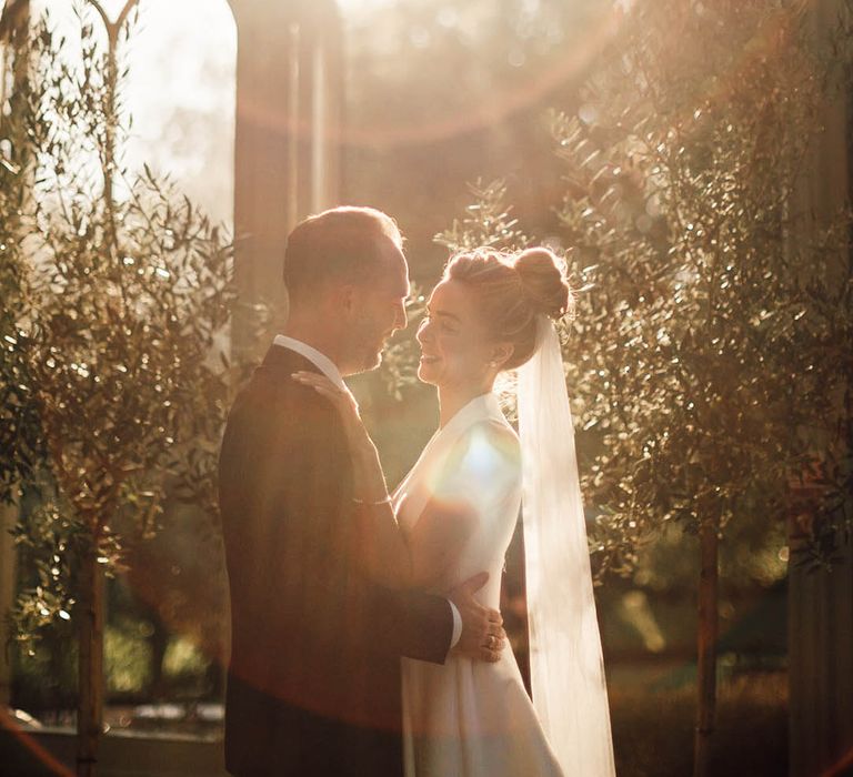 Golden hour wedding photo of the bride and groom at their classic country house wedding 