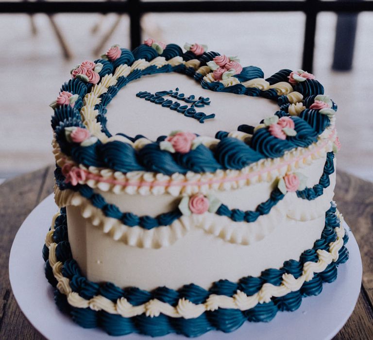 Heart shaped retro wedding cake with blue and pink icing with the top of the cake reading 'Just Married' 