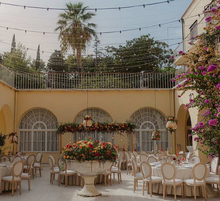 Villa Dalmacija, Split, Croatia destination wedding reception with pink, yellow, red & orange wedding flowers