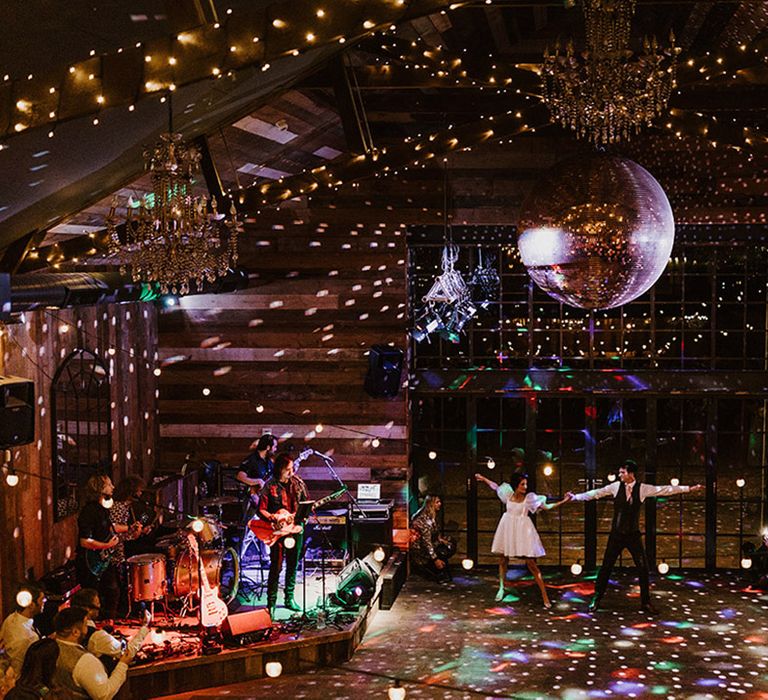 The bride and groom dance their choreographed routine under colourful lights at Wharfedale Grange wedding venue 