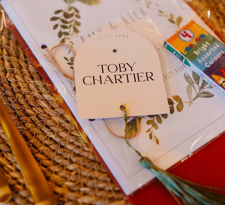 Wedding place setting for children with place name and packet of crayons 