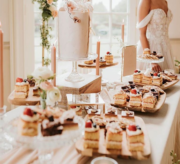 Romantic and elegant wedding theme with dessert table including millionaire shortbread and cakes 