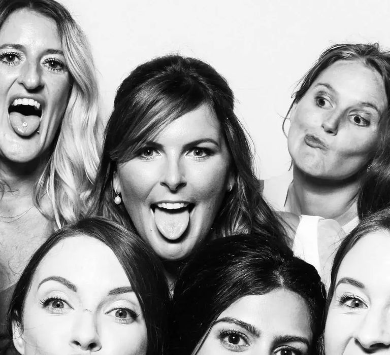 Black and white photo booth style image of a group of women by Studio Rouge Photography