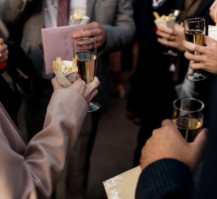 Wedding guests enjoy drinks and chips