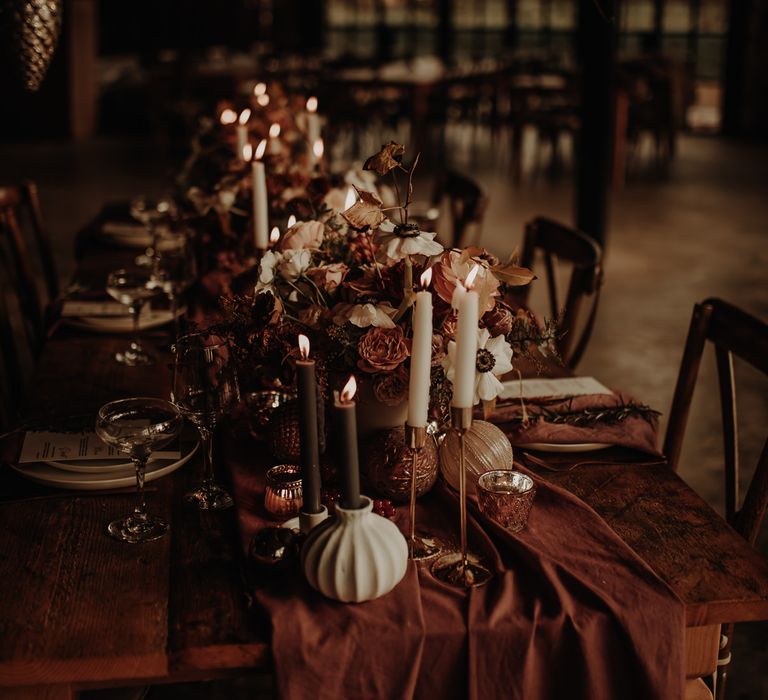 Flower and candle table centrepiece for Christmas wedding inspiration 