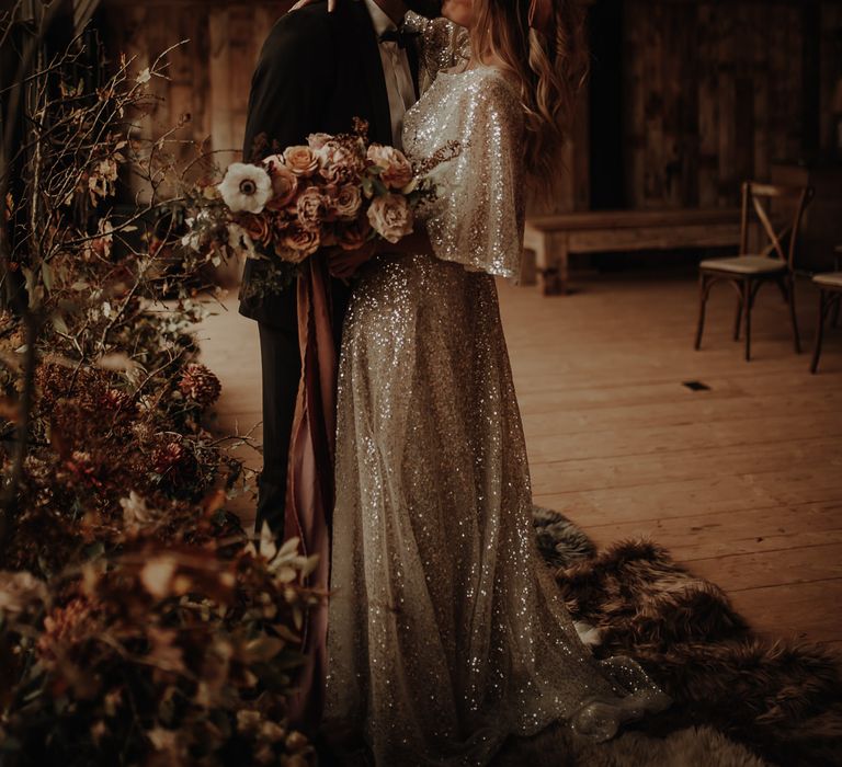 Bride and groom kissing at autumn/winter wedding inspiration shoot