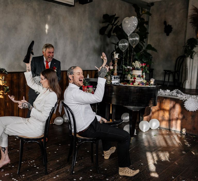 Bride and groom playing Mr & Mrs game at pub wedding reception 