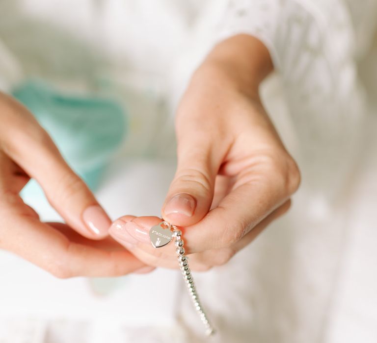 Bride holding personalised wedding bracelet