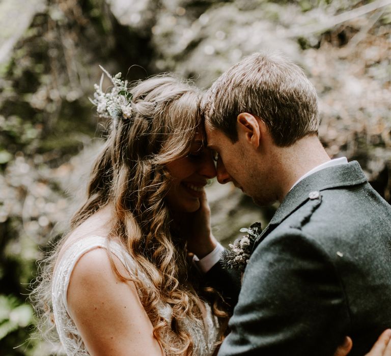 Bride and groom share the love in a forest in the Scottish Highlands