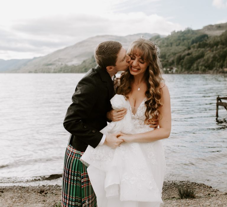 Groom kisses the bride in an intimate micro wedding in a forest in Perthshire