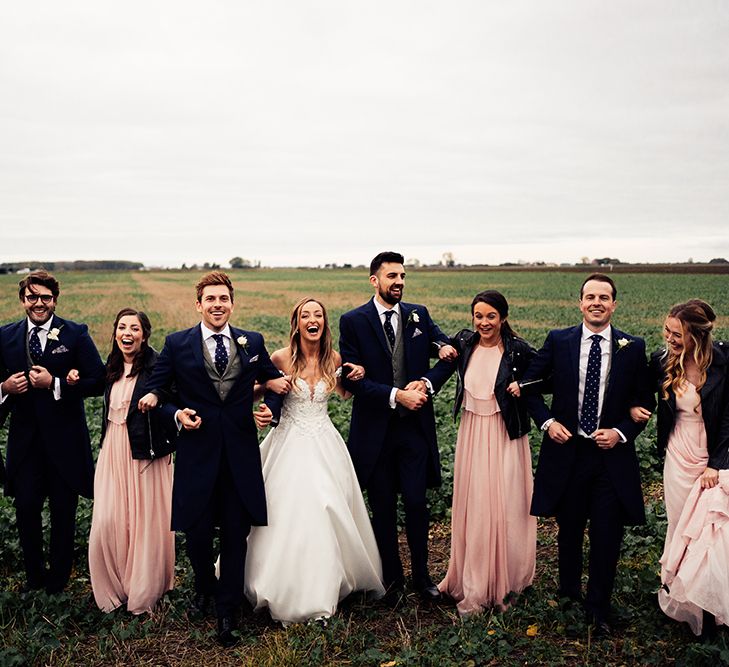 Wedding party photography for countryside wedding with peach bridesmaids 