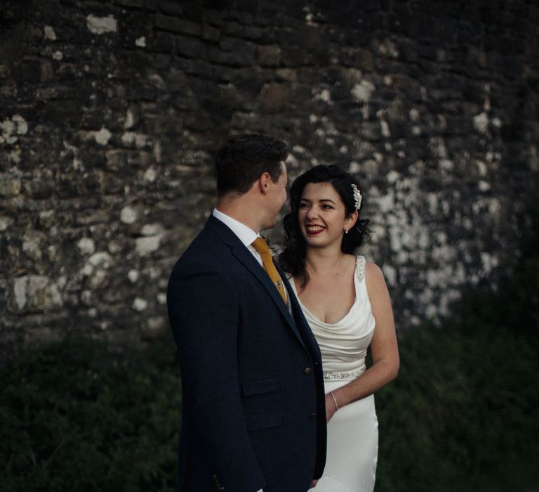 Bride & groom look at each other during post-wedding photoshoot