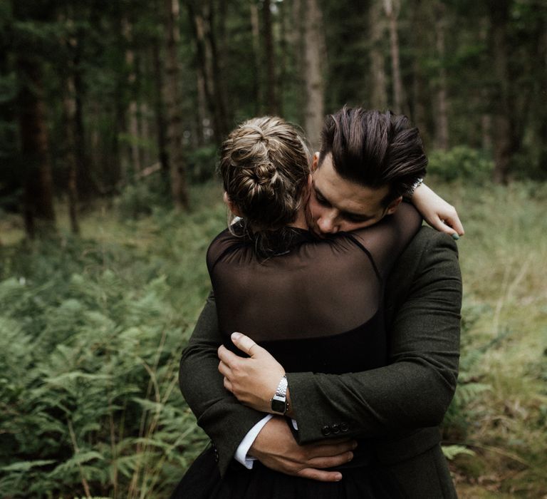 Bride & groom hug in the woodlands during Scottish elopement