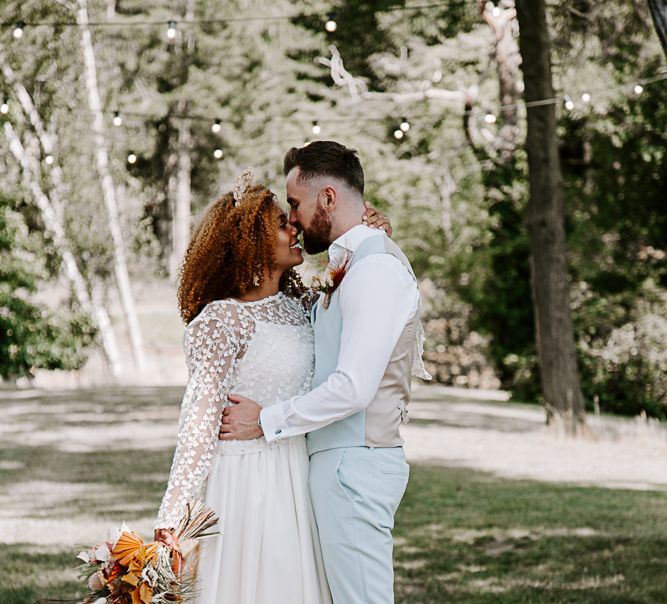 Bride & groom kiss outdoors 