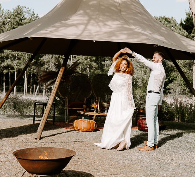 Bride & groom dance outdoors on wedding day in the sunshine