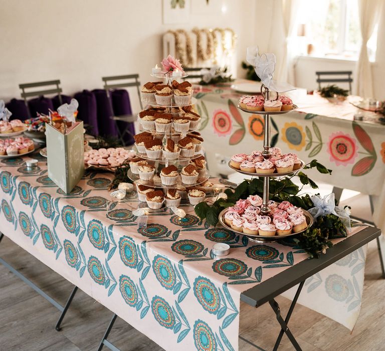 Cupcakes and food on table for garden party wedding 