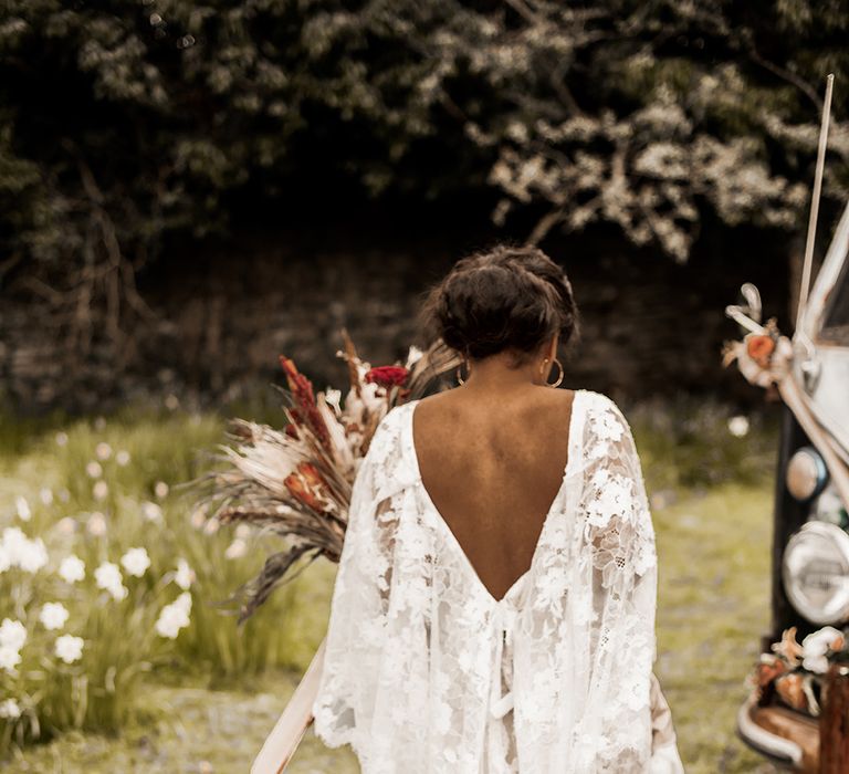 Indian bride in a boho wedding dress with lace batwing sleeve detail 