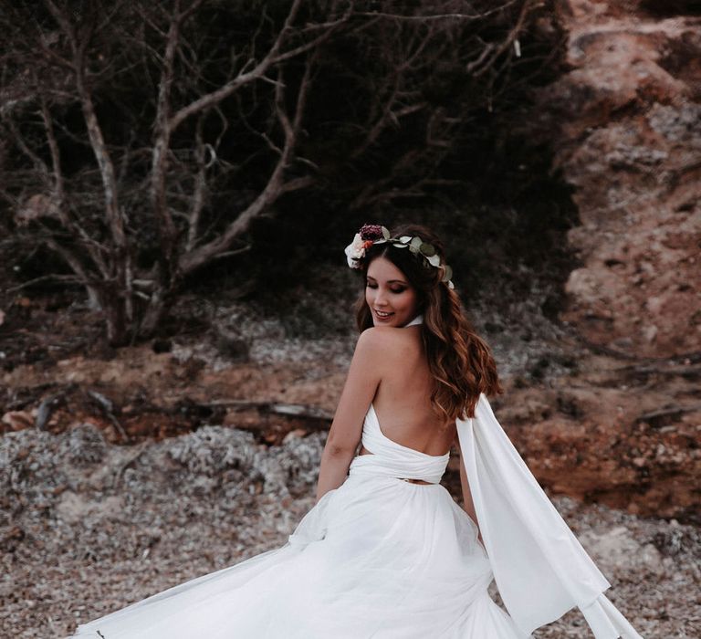 Bride twirling in her tulle wedding dress on the beach