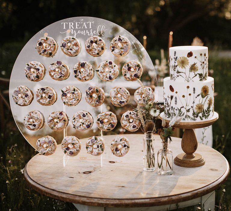 Dessert table with edible flower doughnuts and flower pressed wedding cake 