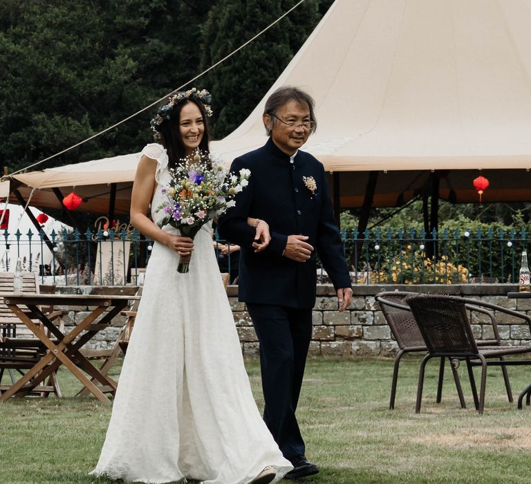 Bride walks with her Father down the aisle on her wedding day